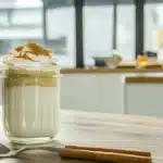 Biscoff oats in a jar with cinnamon and whipped cream