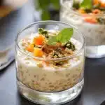 Indian spiced yogurt overnight oats in a glass jar with spiced oil topping