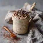Served jar of high protein coffee overnight oats topped with chocolate chips