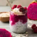 tropical dragon fruit overnight oats in glass jar on wooden table
