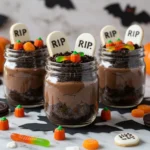 Halloween Dirt Cup Overnight Oats in glass jars with spooky toppings