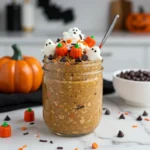 Pumpkin spice overnight oats with spooky toppings in modern kitchen