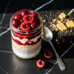 Copycat cherry pie overnight oats layered in a jar with cherry compote