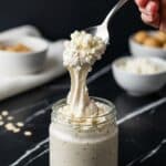 Creamy blended oats scooped from a jar with a spoon