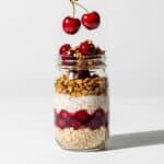 Layering cherry pie overnight oats in a mason jar