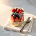 overnight low carb oats served with berries on marble countertop