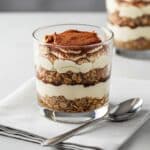 Tiramisu protein oats served in glass with cocoa topping